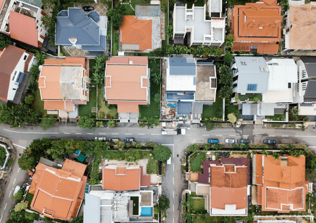 Aerial view of a residential neighborhood showing a variety of house designs and roof colors.