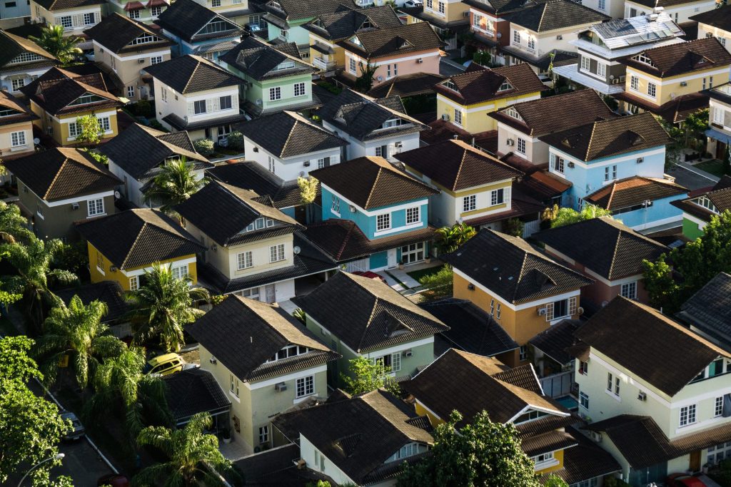 Aerial view of a dense residential neighborhood with rows of colorful houses.