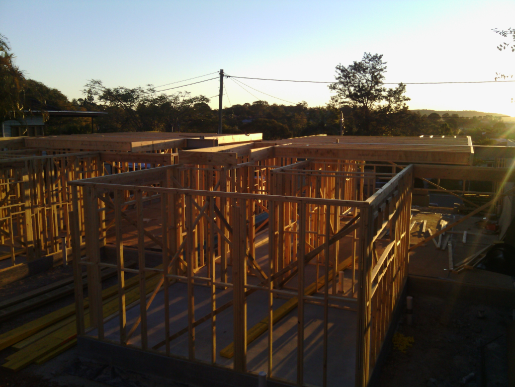 wooden house frame with sunrise